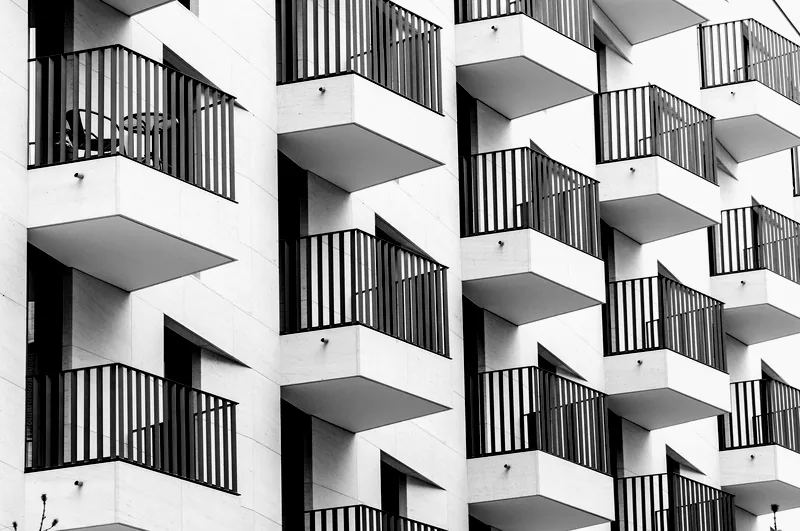 Repeating balconies on a contemporary apartment block, black and white