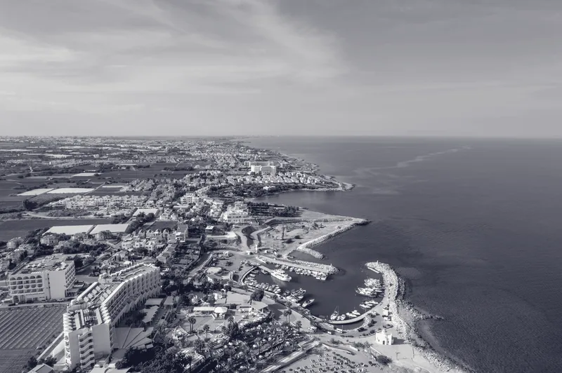 Aerial view of the Cyprus coastline with hotels, marina and beachfront